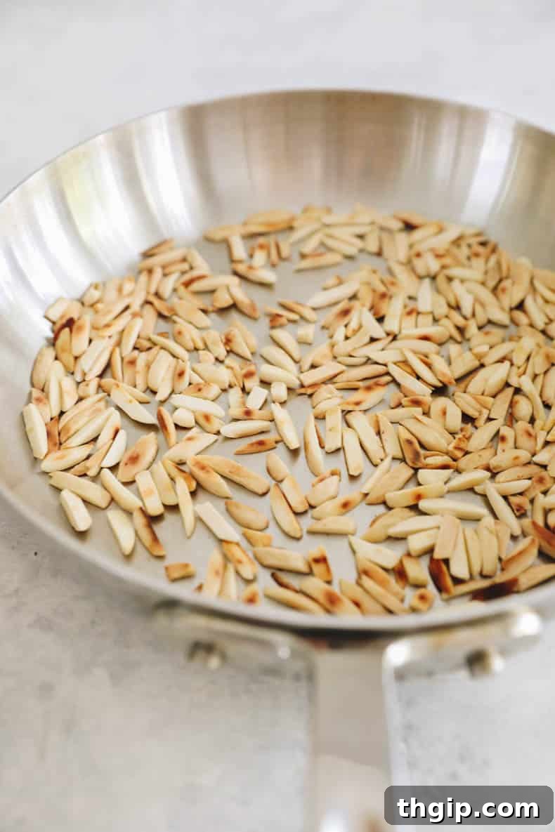 Vibrant Bean Delight 3 toasted slivered almonds in a shallow pan.