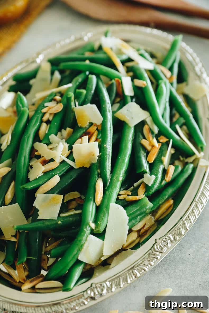 Vibrant Bean Delight 5 green bean salad on a silver plate topped with parmesan and almonds.