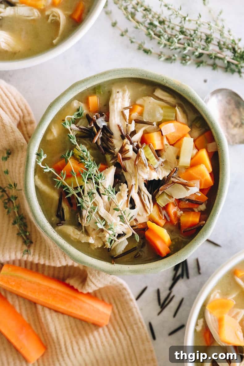 Creamy Chicken Wild Rice Delight 9 An inviting overhead view of a large green bowl filled with homemade creamy chicken wild rice soup, garnished beautifully and ready to be enjoyed as a hearty meal.