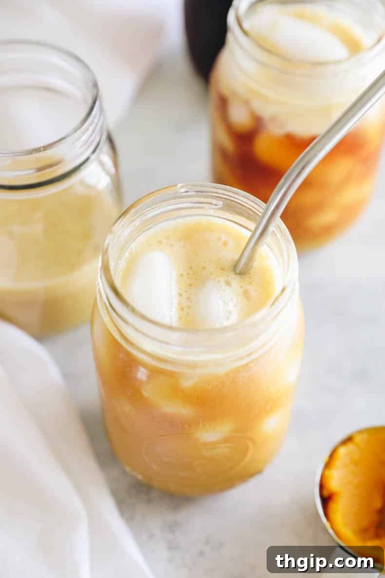 Velvet Pumpkin Cold Brew 2 Homemade Pumpkin Cream Cold Brew served over ice in a mason jar, garnished with a sprinkle of pumpkin spice.