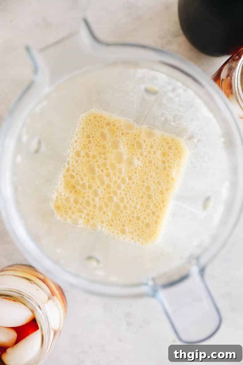 Velvet Pumpkin Cold Brew 3 Pumpkin cream mixture blending in a high-speed blender for cold foam.
