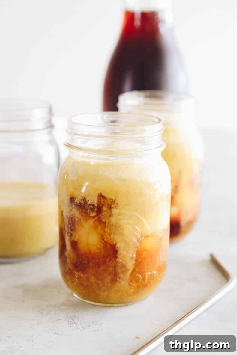 Velvet Pumpkin Cold Brew 4 Freshly poured pumpkin spice cold brew in a mason jar, ready for foam.