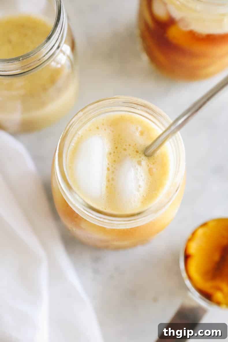 Velvet Pumpkin Cold Brew 5 Refreshing Pumpkin Cream Cold Brew with creamy foam and ice in a glass jar.