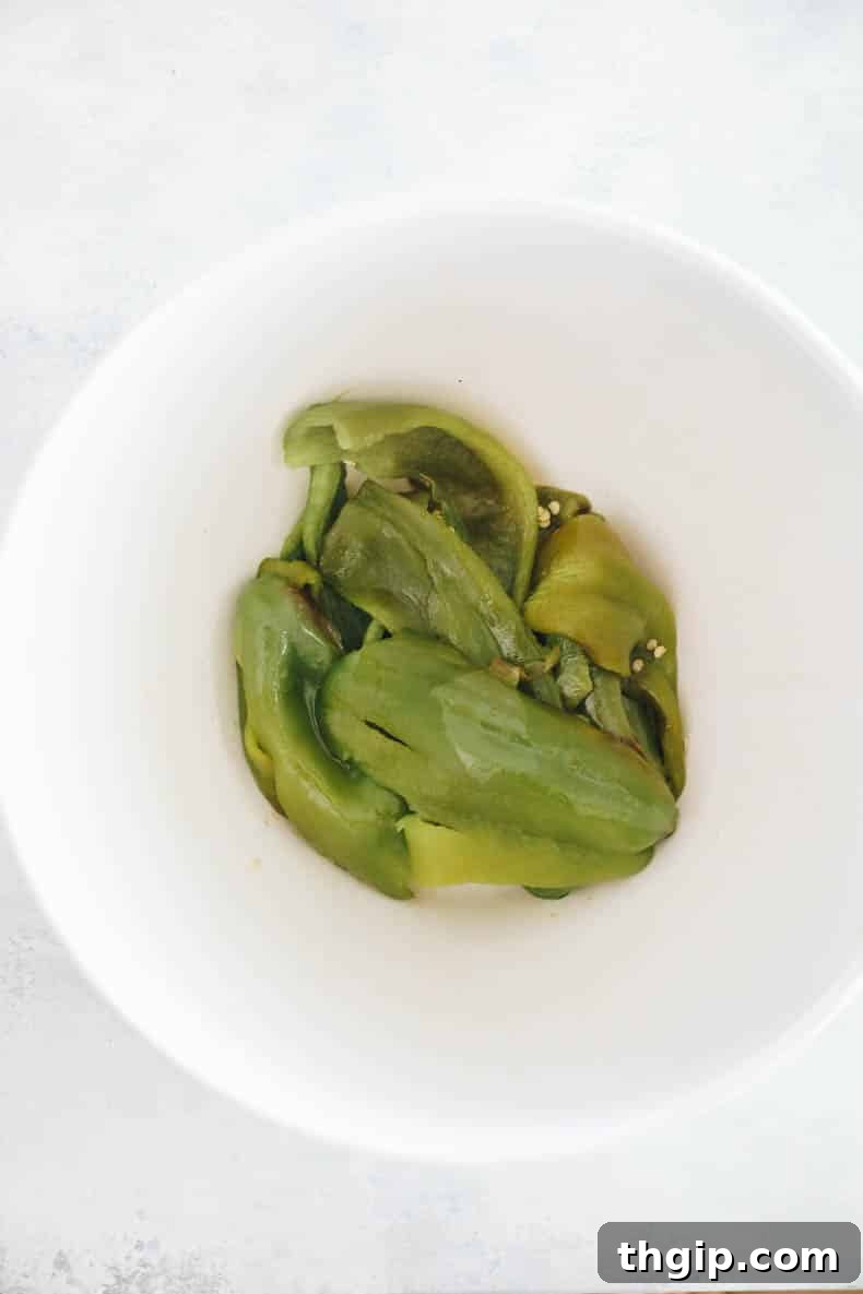 Zesty Green Enchilada Sauce 5 peeled hatch peppers in a bowl.