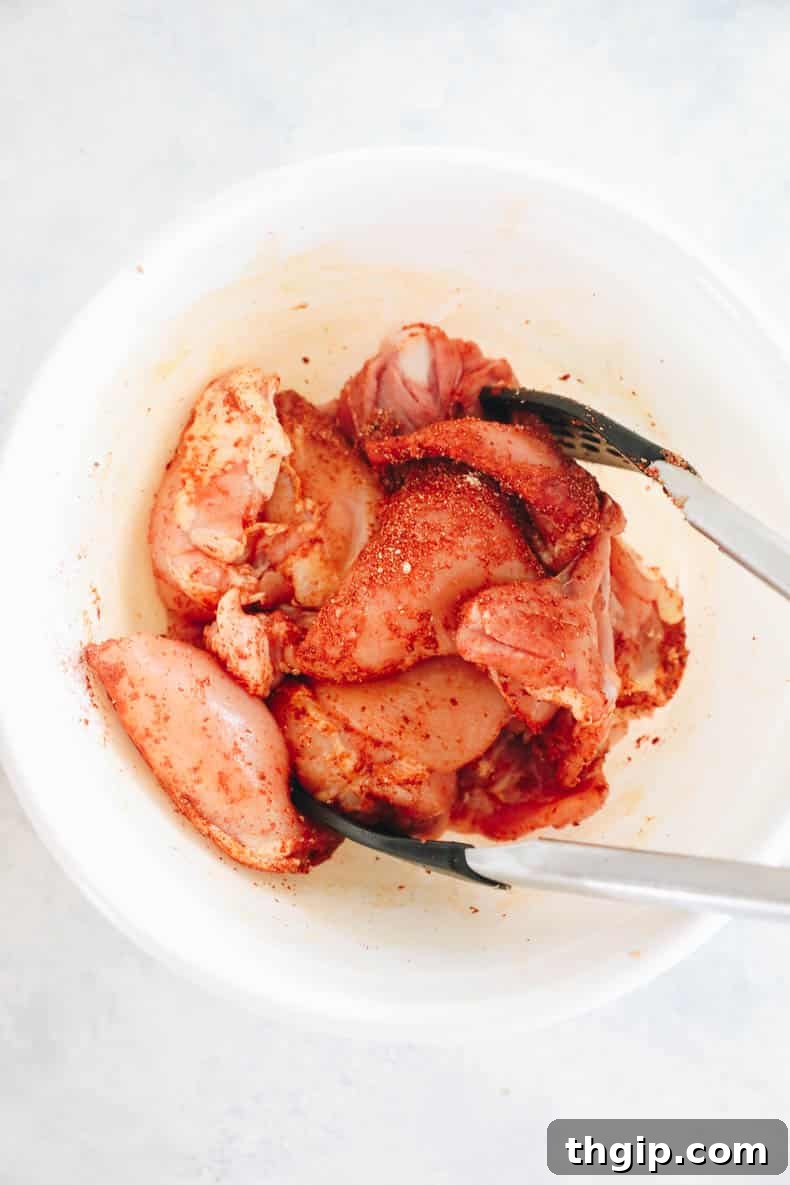 Effortless Skillet Chicken and Rice 3 marinated chicken thighs in a white bowl