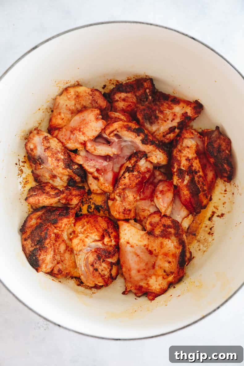 Effortless Skillet Chicken and Rice 4 browned chicken thighs in a dutch oven.