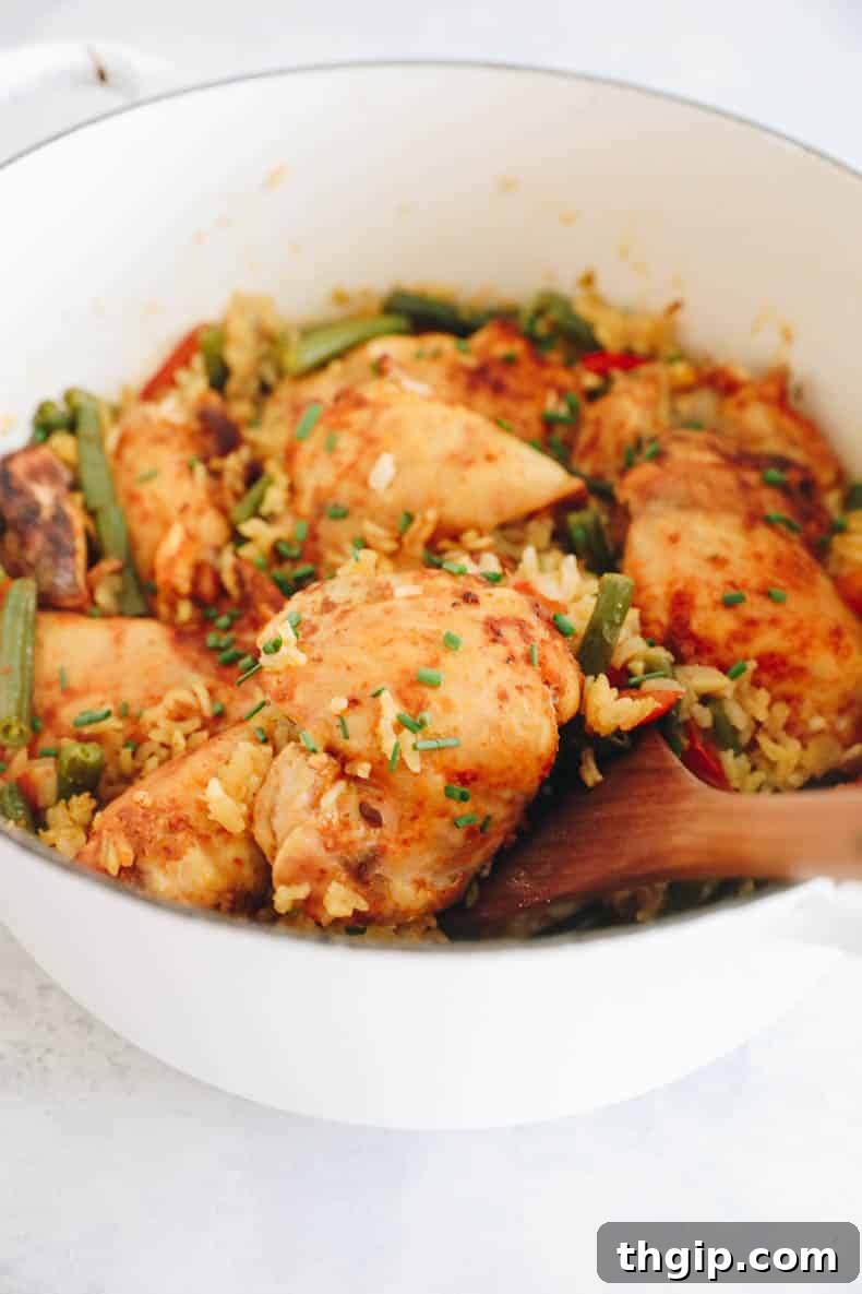 Effortless Skillet Chicken and Rice 7 close up image of a chicken thigh in this one pot chicken and rice recipe.