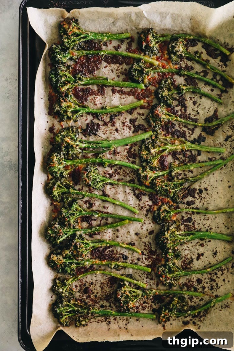 Golden Roasted Broccolini 5 Roasted broccolini on a sheet pan sprinkled with parmesan.