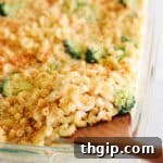 Up close image of a spoon scooping out noodles from healthy mac and cheese, highlighting the creamy texture.