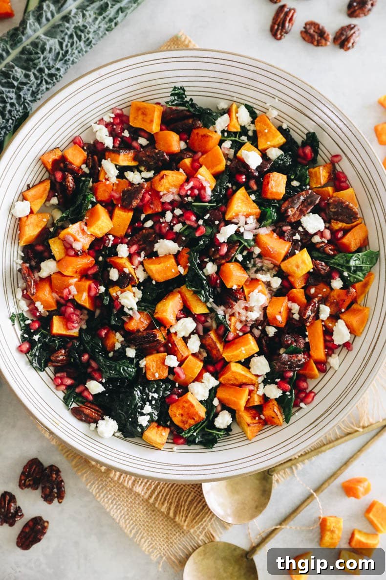 Autumn Squash Harvest Bowl 2 Vibrant kale fall salad generously topped with perfectly roasted butternut squash, glistening pomegranate seeds, crunchy candied pecans, and crumbled feta cheese.
