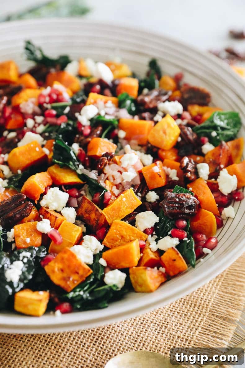 Autumn Squash Harvest Bowl 6 A large, inviting salad bowl filled with the completed butternut squash salad, featuring kale, roasted squash, and other vibrant toppings.