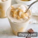 overhead image of a thick chocolate peanut butter smoothie with drizzled peanut butter and a metal straw.