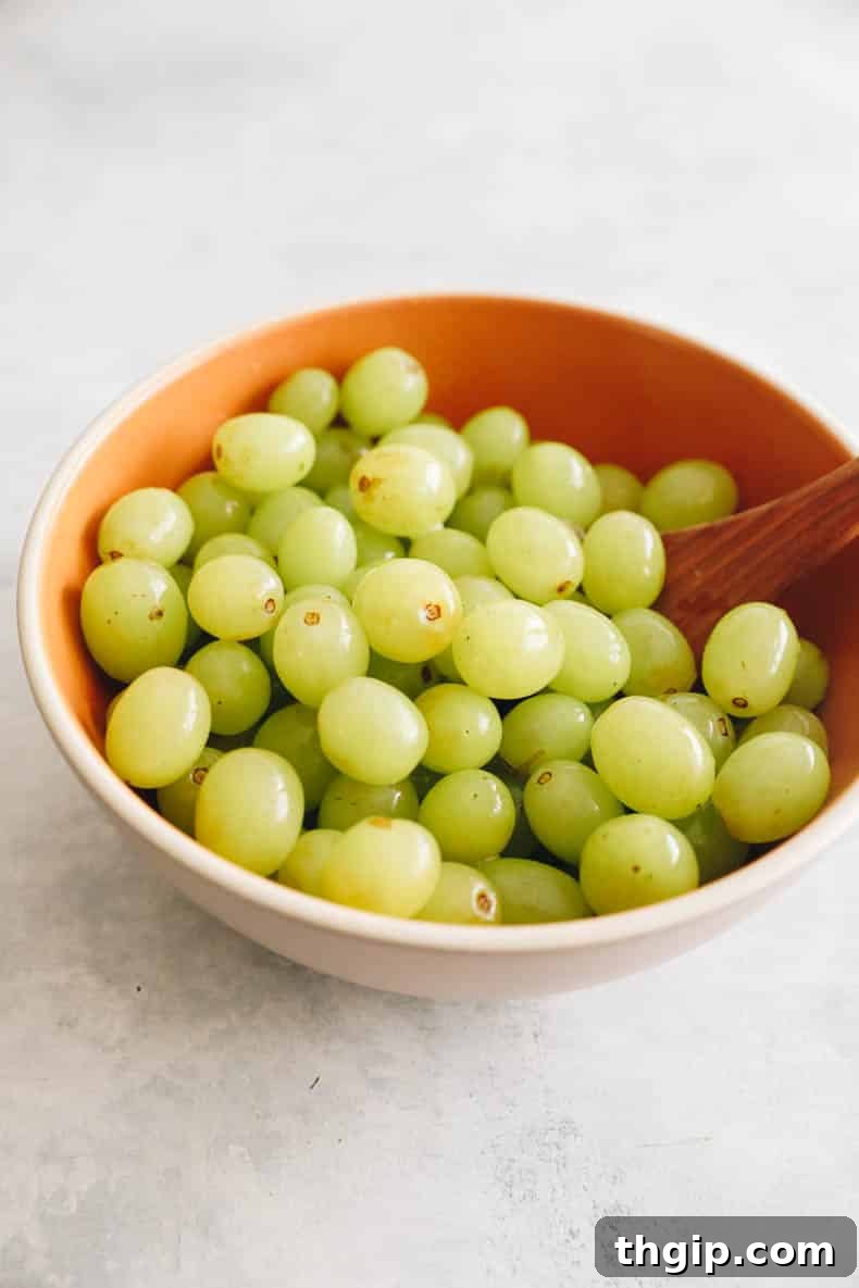 green grapes in a brown bowl.