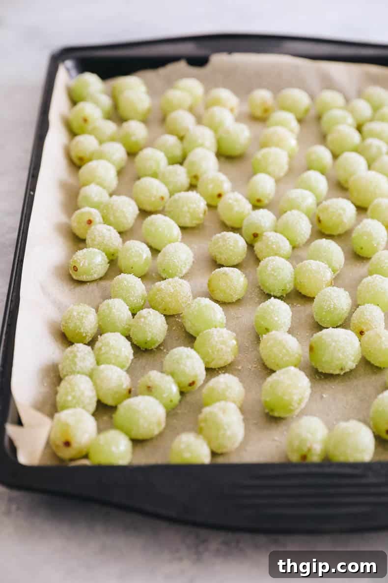candy grapes on a baking sheet with parchment paper