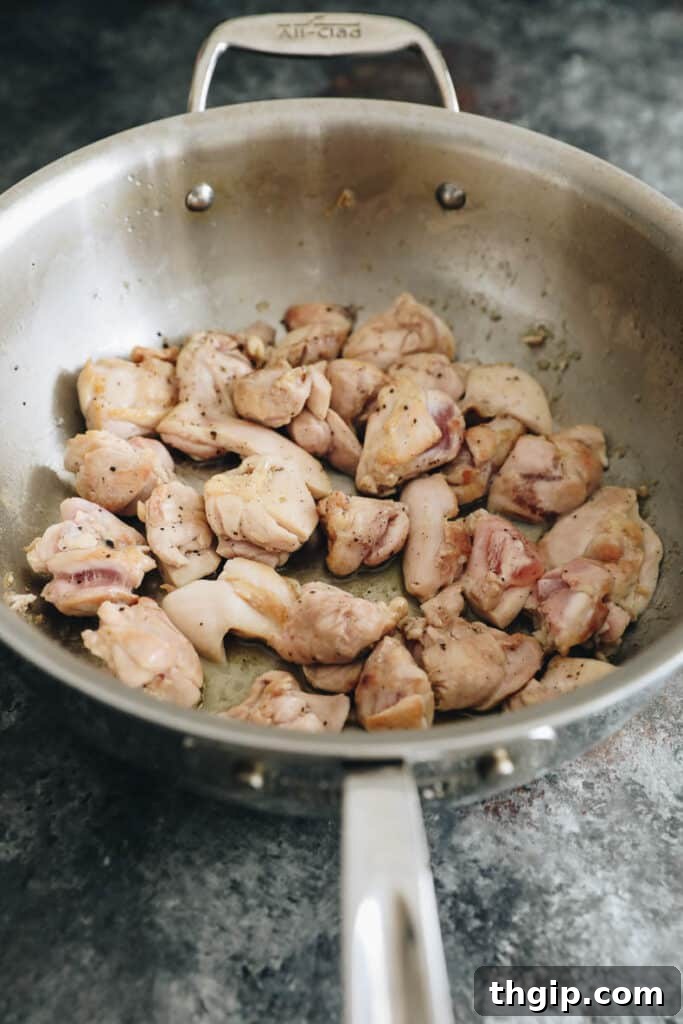 Cooked chicken thighs in a wok.