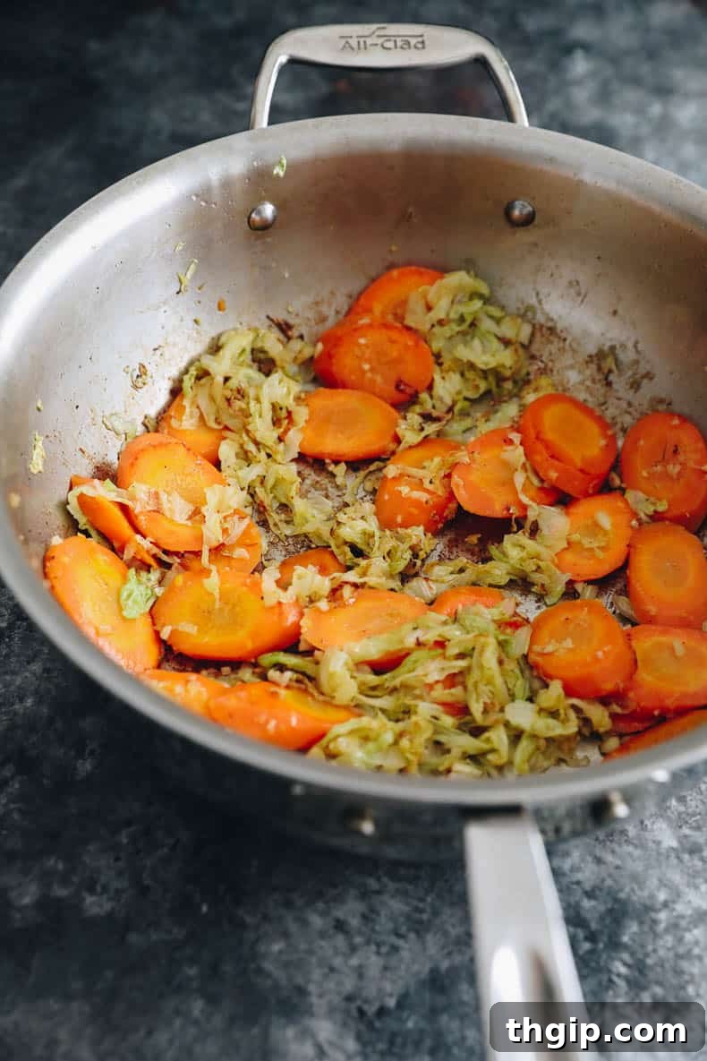 cooked carrots and cabbage in a wok.