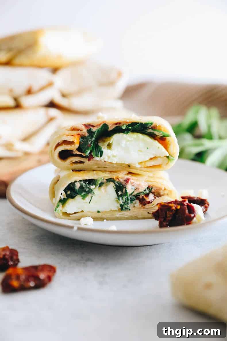 The Perfect Homemade Spinach Feta Breakfast Wrap 2 Delicious homemade spinach feta wrap on a pristine white plate, ready to be enjoyed.