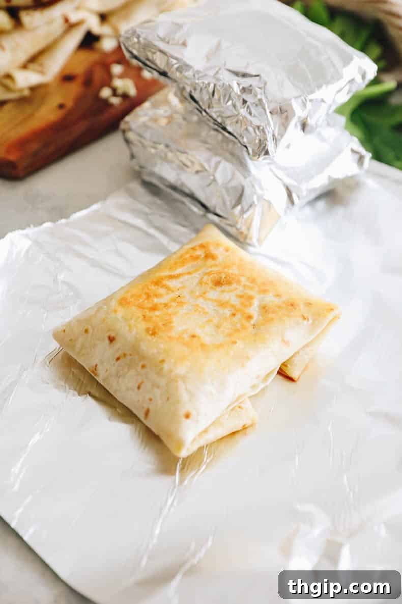 The Perfect Homemade Spinach Feta Breakfast Wrap 10 Starbucks spinach feta wrap on a piece of tinfoil, perfectly prepared for freezing and future enjoyment.