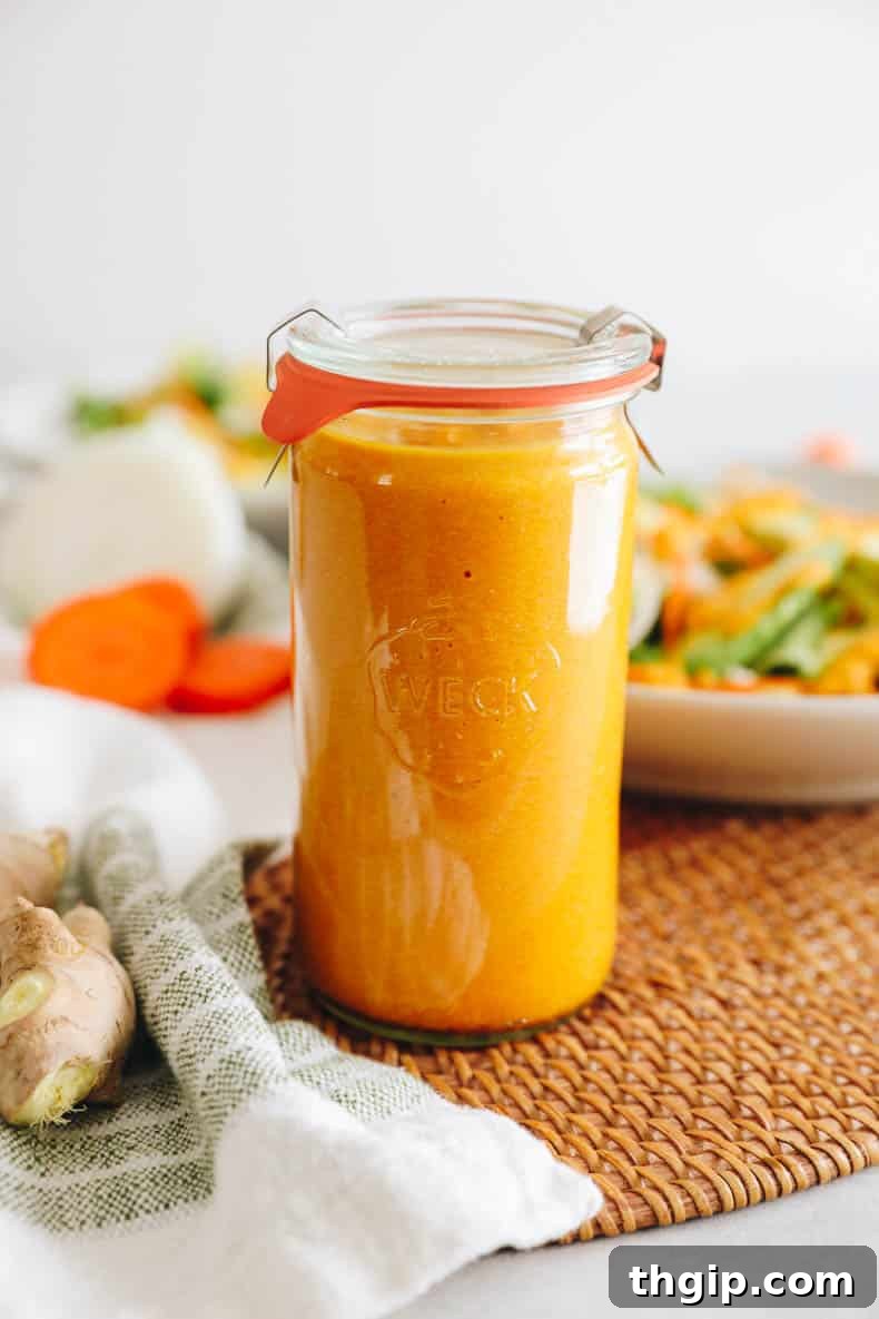 Vibrant Ginger Dressing 2 Freshly made ginger salad dressing in a clear mason jar, ready to be served.