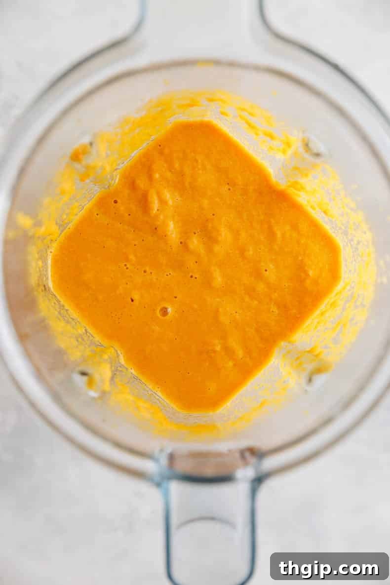 Vibrant Ginger Dressing 4 Ginger salad dressing being blended in a high-speed blender, showing its creamy texture.