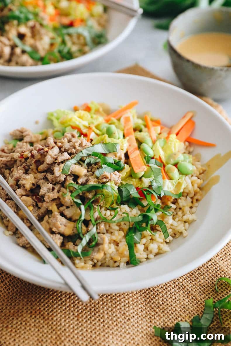 Fragrant Thai Basil Turkey Bowls 2 Thai bowl with ground turkey, sliced thai basil, carrots, edamame, cabbage and green onions topped with a peanut sauce.