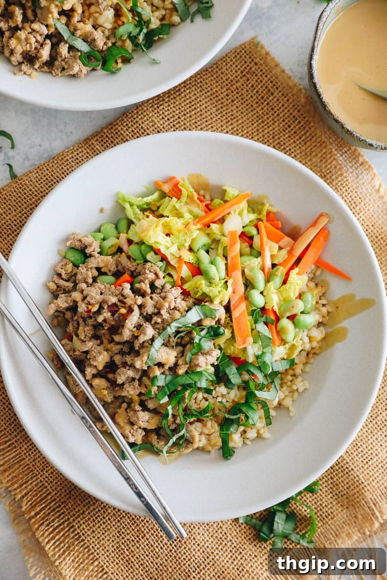 Fragrant Thai Basil Turkey Bowls 6 overhead image of turkey thai bowls in a white bowl with chopsticks.