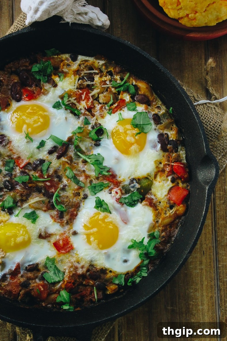 Fiery Baked Shakshuka 4 Another appealing shot of Baked Chili Shakshuka in a rustic skillet, showcasing the rich chili and perfectly cooked eggs.