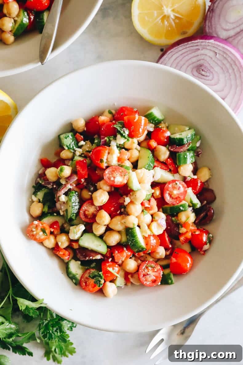 Vibrant Mediterranean Chickpea Medley 7 An overhead view of the finished Mediterranean chickpea salad presented in a white bowl, showcasing all its colorful ingredients.