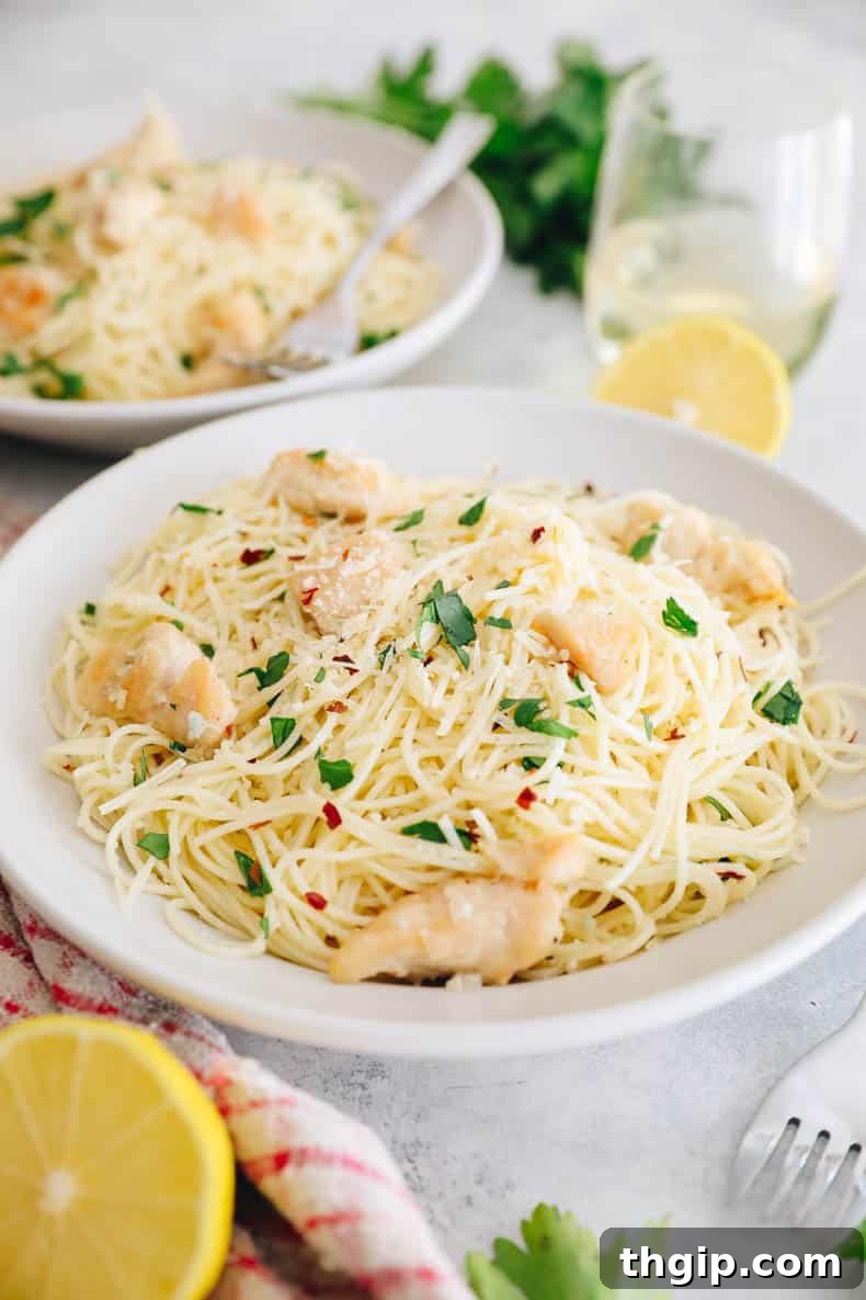 Garlic Butter Lemon Chicken 2 chicken scampi in a white plate with parsley.