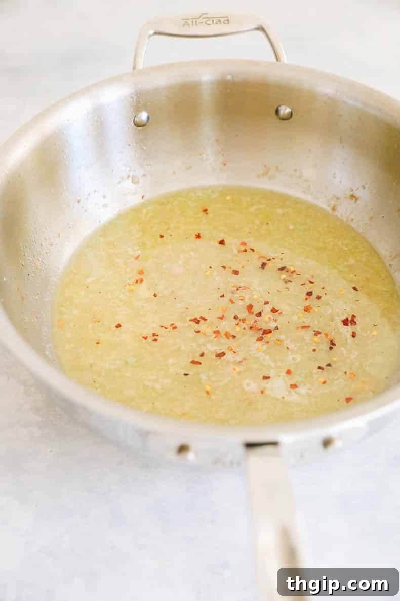 Garlic Butter Lemon Chicken 6 scampi sauce in a pot.