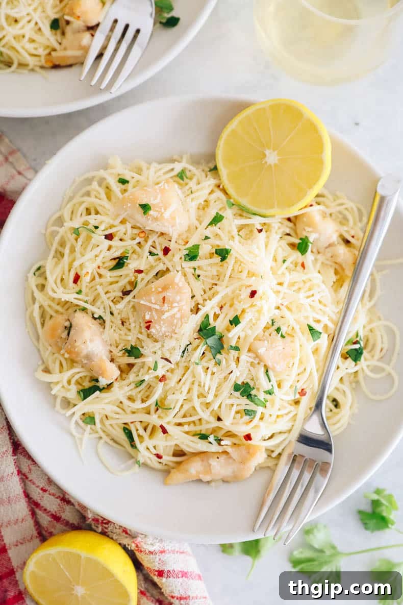Garlic Butter Lemon Chicken 9 chicken scampi in a white bowl with lemon.