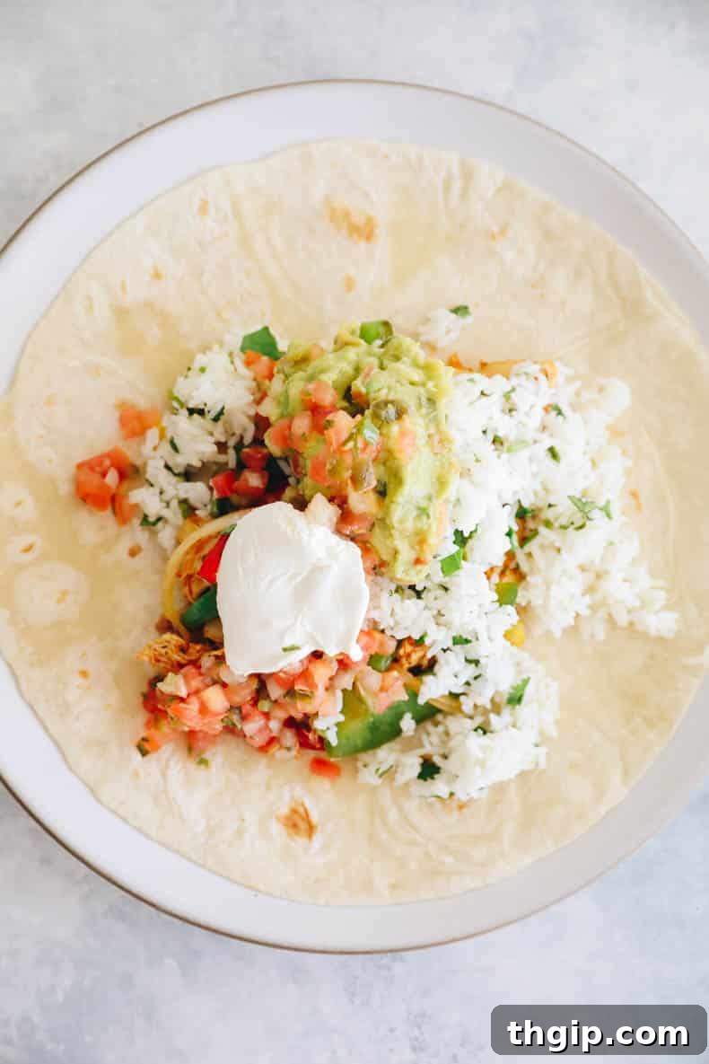Simple Savory Chicken Burritos 6 Step-by-step image of a burrito being wrapped, showing the initial fold of the sides.