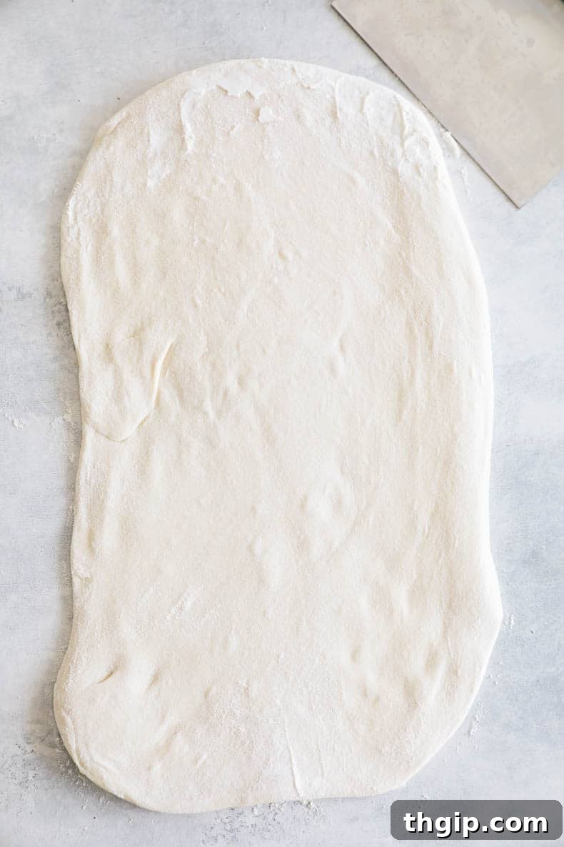pizza dough rolled out into a rectangle, lightly floured.