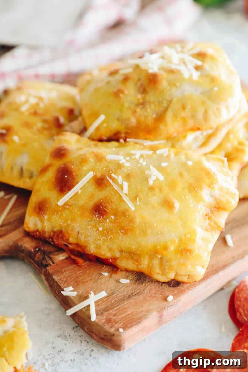 pizza pocket on a cutting board topped with parmesan cheese and fresh basil.