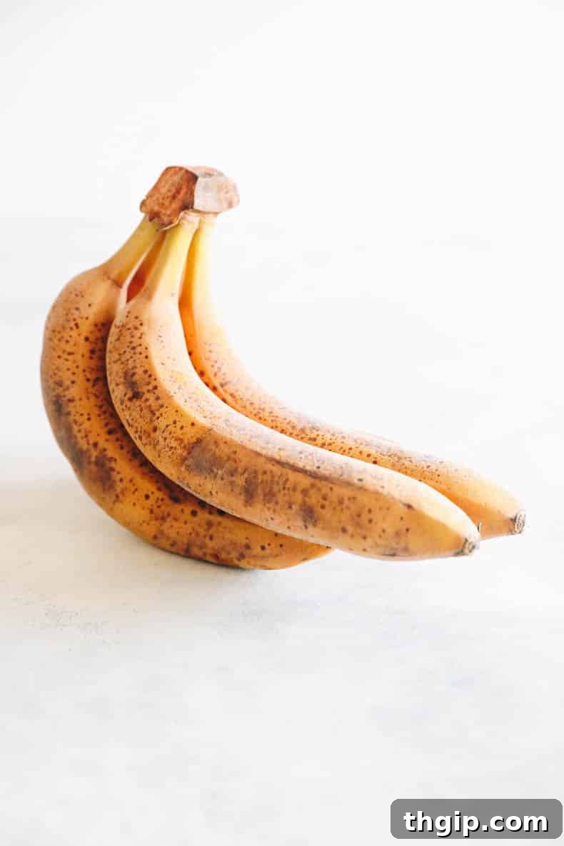 Two dark, frozen bananas still in their peels, indicating they've been stored directly in the freezer.