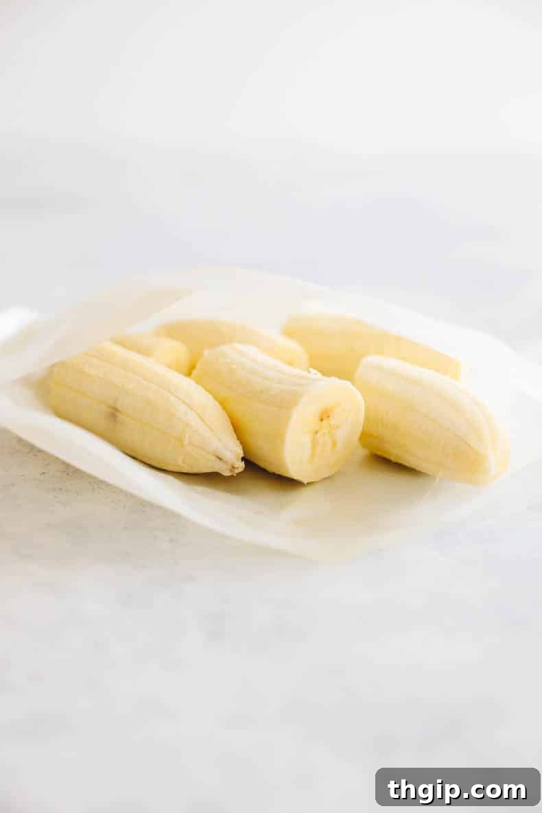 Several peeled frozen bananas stored in a clear, reusable Ziploc-style bag, showing their convenience for quick use.