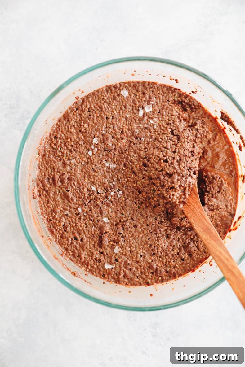 The chocolate chia pudding mixture after it has been thoroughly stirred, appearing smooth and uniform before chilling.