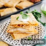 sheet pan quesadillas cut into rectangles and stacked on a plate