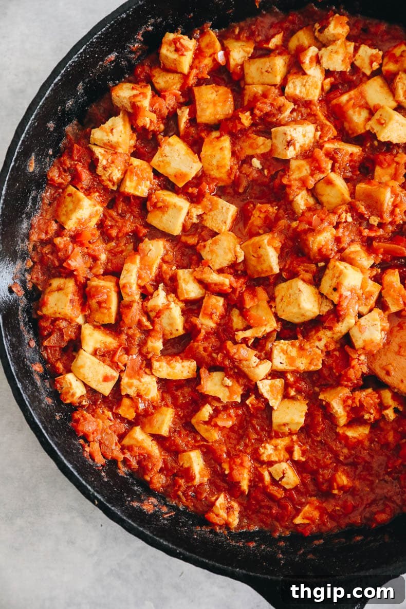 Crispy vegan sofritas made from tofu in a rustic cast iron skillet, ready to serve.