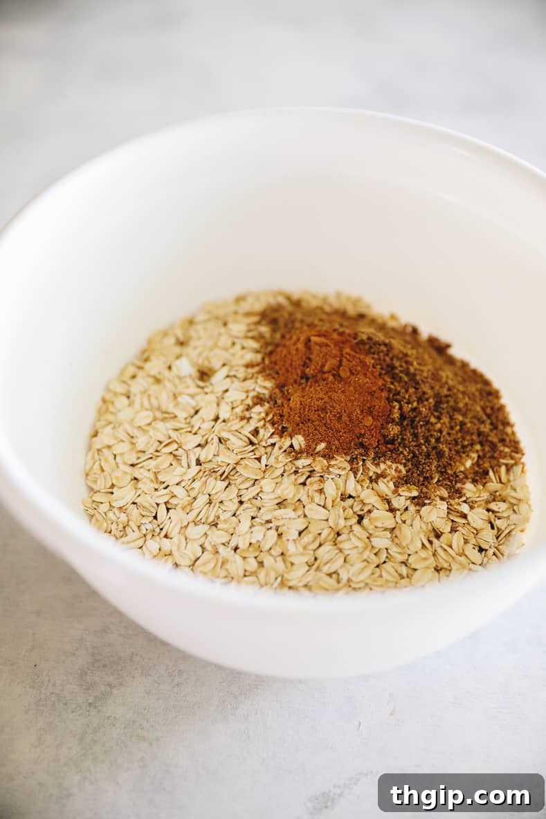 White mixing bowl with oatmeal and spices.