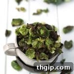A bowl full of freshly made Salt and Vinegar Brussels Sprout Chips, ready to be served.
