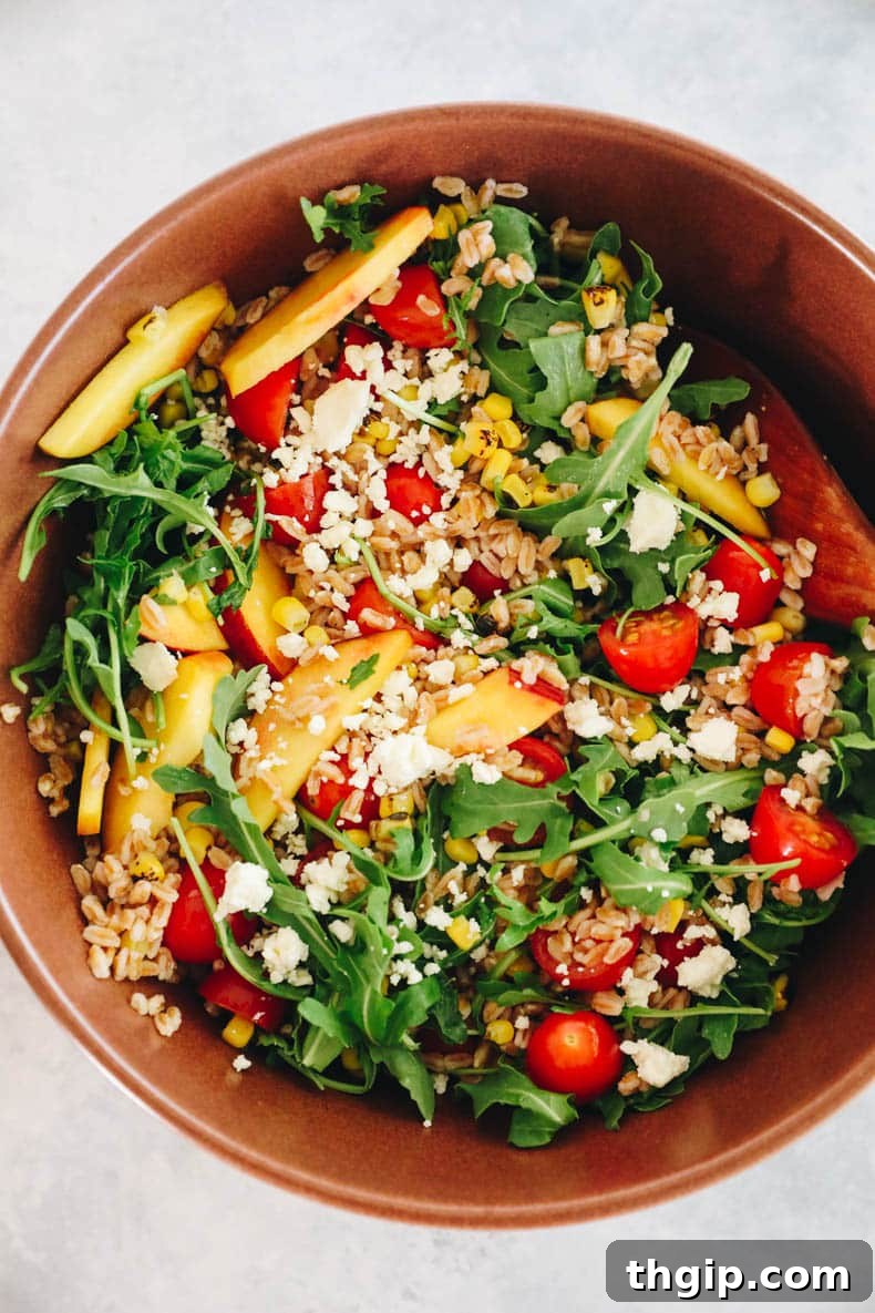 Vibrant Summer Farro Bowl 4 un-dressed farro salad in a large brown bowl, showcasing all the fresh ingredients before dressing