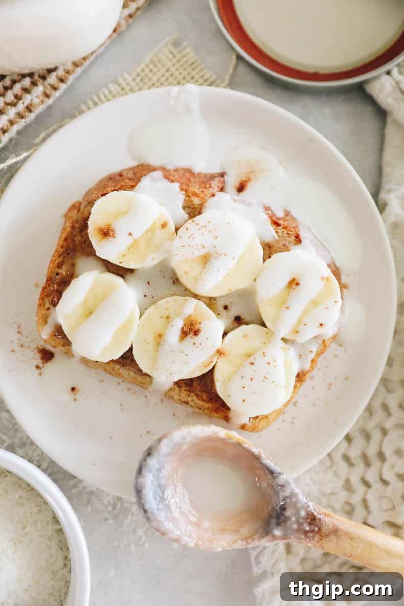 Peanut butter banana toast generously drizzled with homemade coconut butter, a delightful breakfast or snack.