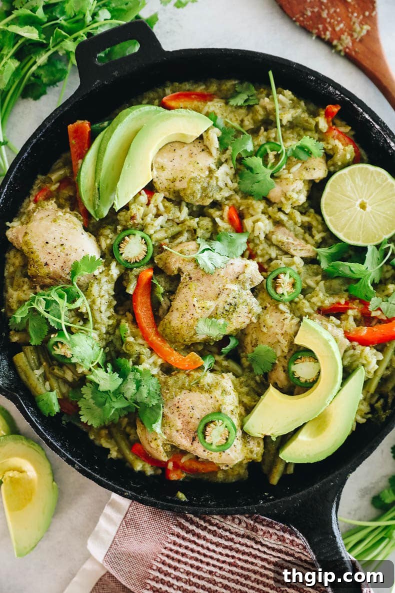 Zesty One-Pan Cilantro Lime Chicken and Rice 2 Delicious one-pot cilantro lime chicken thighs with rice and nutritious veggies served in a rustic cast iron pan, ready to eat.