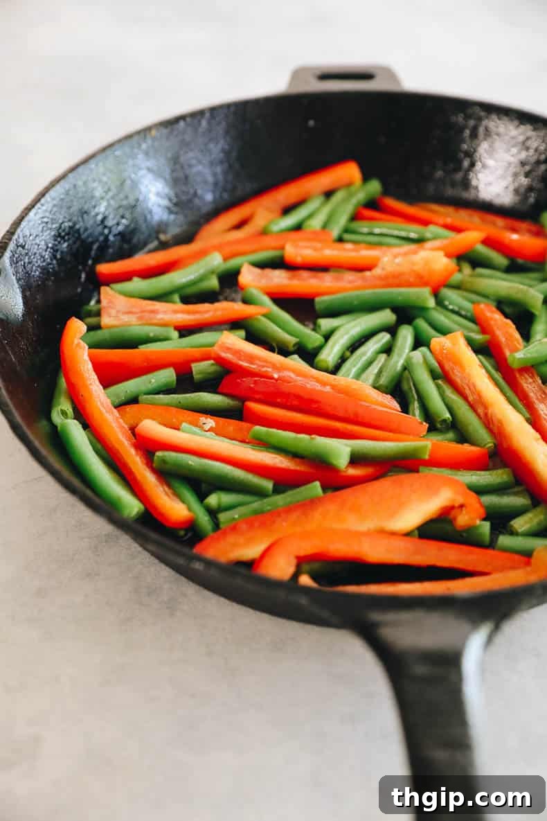 Zesty One-Pan Cilantro Lime Chicken and Rice 4 Colorful bell pepper and green beans lightly cooked in a cast iron pot.