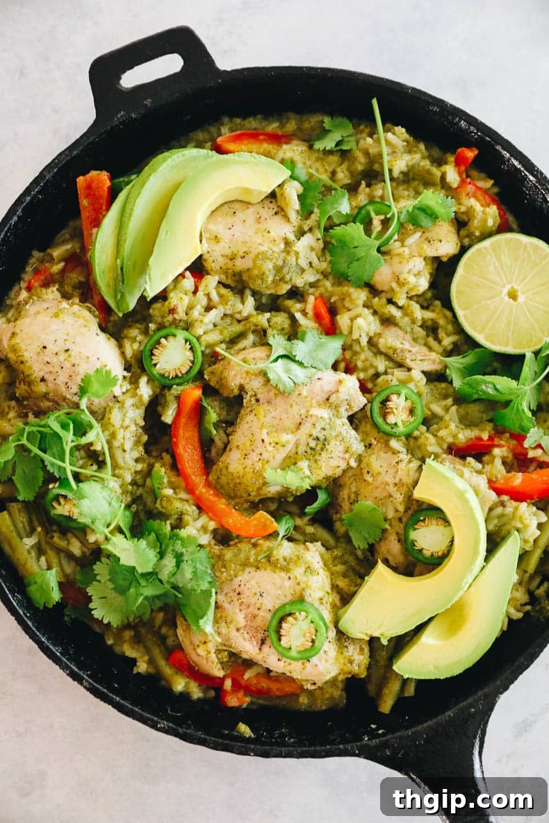 Zesty One-Pan Cilantro Lime Chicken and Rice 6 Fully cooked one-pot cilantro lime chicken and rice, garnished with fresh avocado, cilantro, and jalapeño, ready to serve.