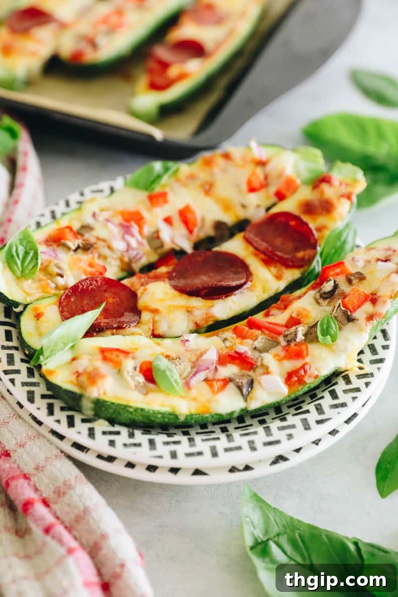 Pizza-Stuffed Zucchini 6 Two vibrant veggie zucchini pizzas and one with savory pepperoni, all beautifully baked and ready to eat.