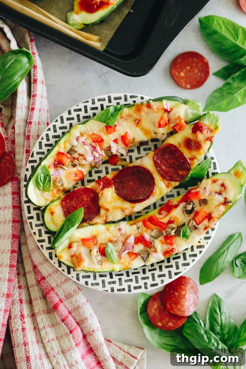 Pizza-Stuffed Zucchini 8 Overhead shot of several zucchini pizzas, showcasing a variety of toppings and the vibrant colors of the ingredients.