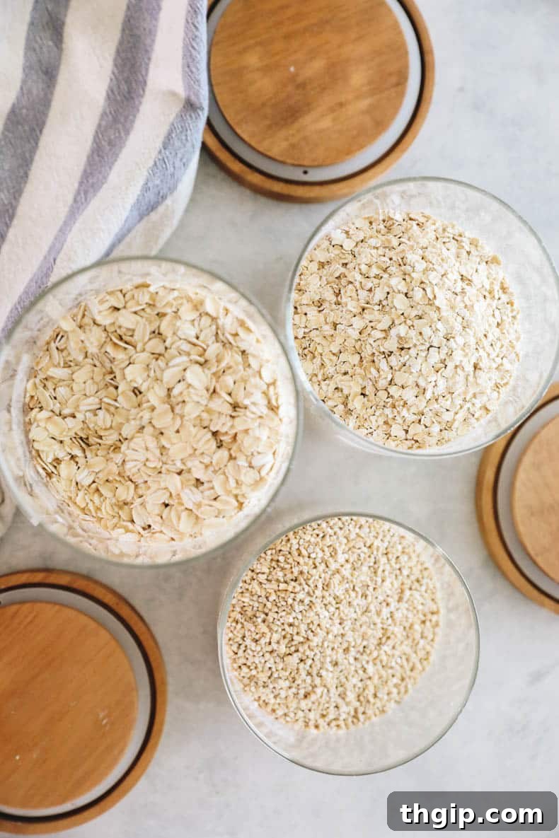 Mastering Your Morning Oats 3 Three clear glass jars showcasing different varieties of oats: one filled with large, flat rolled oats, another with small, chunky steel-cut oats, and a third with finely cut quick-cooking oats.