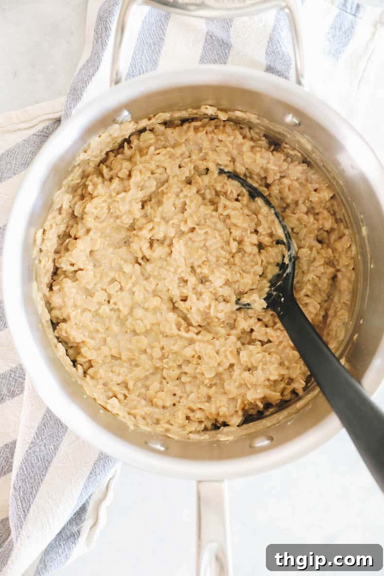 Mastering Your Morning Oats 5 A close-up shot of perfectly cooked oatmeal in a pot, rich and creamy, ready to be served.